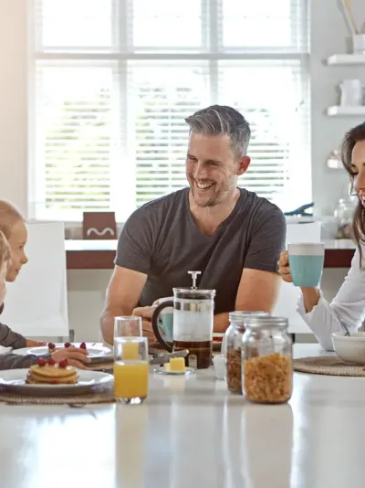 gezin met twee kinderen aan tafel gezin met twee kinderen aan tafel
